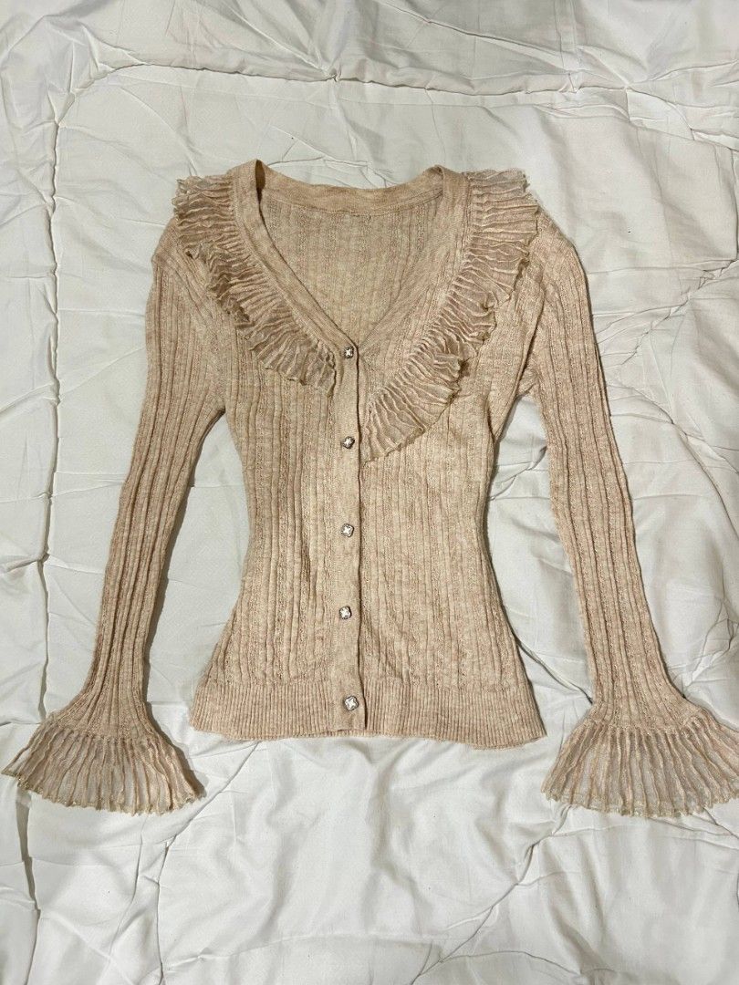 Beige Ruffled V-Neck Button-Up Cardigan (Category: Coats, Jackets and Outerwear) located in Caloocan City. Submitted by geliethrift_26 (Listing ID 1461804605, Image 1). Description: fits small to med since it's stretchable fabric is NOT itchyyyyy, promise no issue snatched for design purposes only.