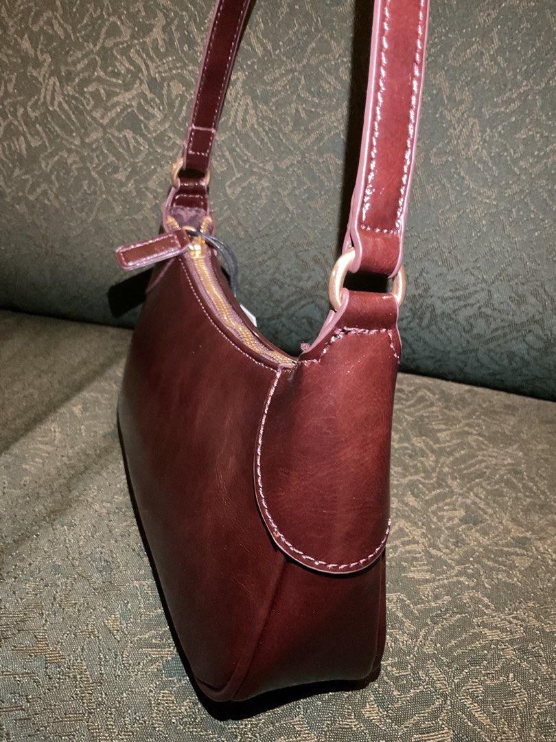 Bershka Leather Effect Brown Shoulder Bag (Category: Shoulder Bags) located in Las Pinas. Submitted by kateanne419 (Listing ID 1461988555, Image 3). Description: Brand new Bershka brown shoulder bag with shiny finish. Features zip closure, single strap, and original tag attached. One size..