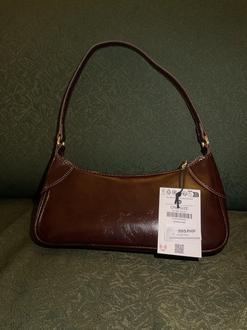 Bershka Leather Effect Brown Shoulder Bag (Category: Shoulder Bags) located in Las Pinas. Submitted by kateanne419 (Listing ID 1461988555, Image 1). Description: Brand new Bershka brown shoulder bag with shiny finish. Features zip closure, single strap, and original tag attached. One size..