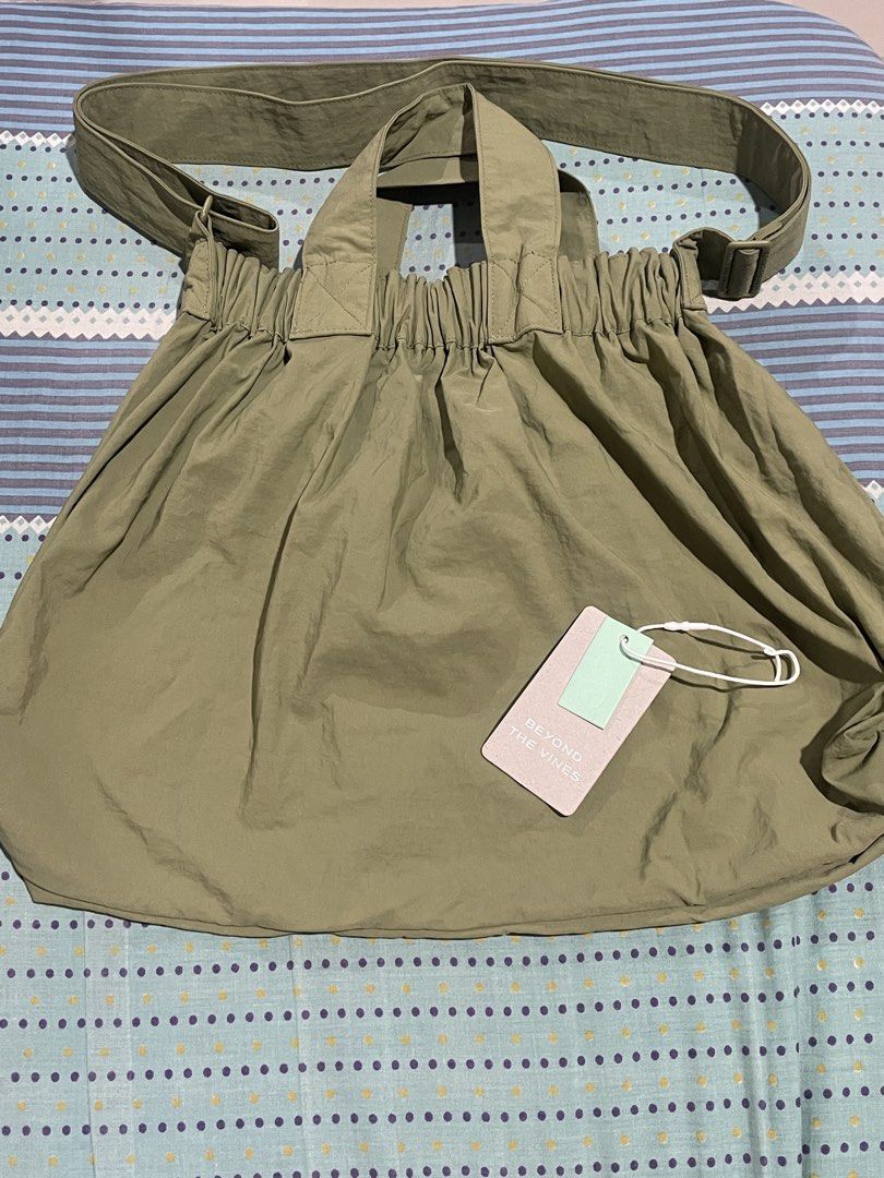 Beyond The Vines Dumpling Bag in Light Olive (Category: Cross-body Bags) located in Quezon City. Submitted by engelboi (Listing ID 1461835505, Image 2). Description: Beyond The Vines Dumpling Bag Color: Light Olive Size: M ₱3250 (Original Price: ₱4190) + shipping fee Bought online from the BTV PH Used 2-3x only Material: 100% Nylon Features: Unique gathered top, front pocket, adjustable strap RFS: Size too big for me 😔 ⭕️Strictly payment first b