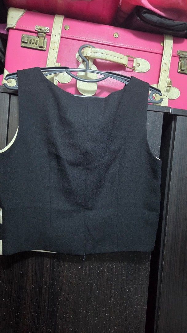 Black and White Striped Sleeveless Top (Category: Sleeveless) located in Quezon City. Submitted by kctheexplorer05 (Listing ID 1461921465, Image 2). Description: - Sleeveless formal top - Bold black and white stripes - Shiny, textured stripe pattern on the front - Plain black back - Simple and chic design - Easy to pair with various bottoms.