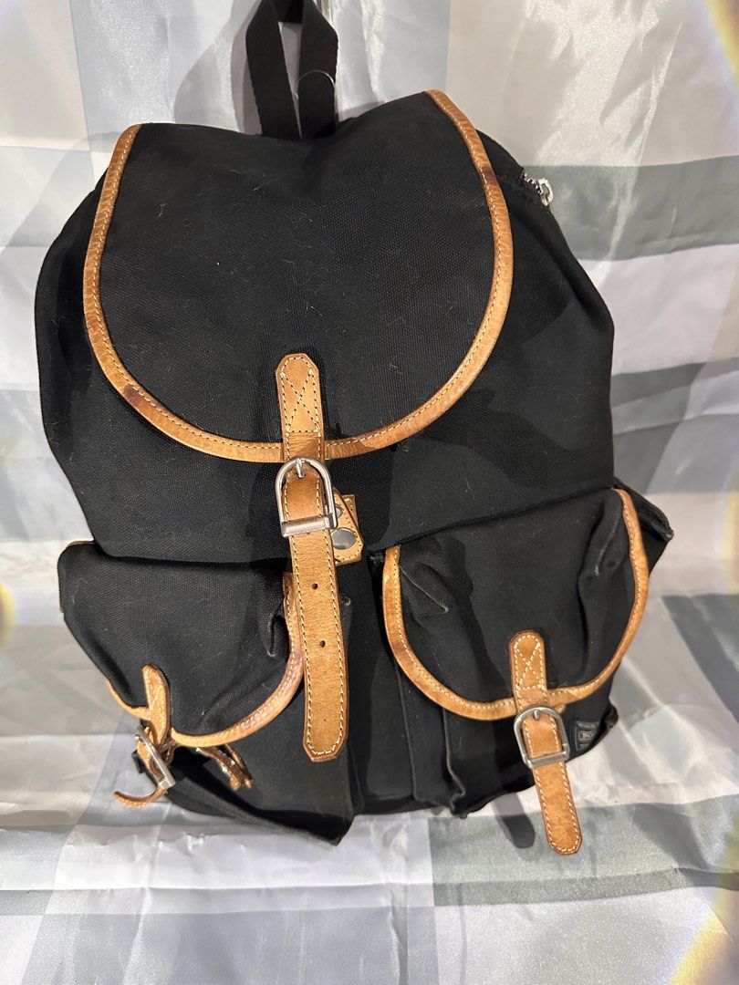 Black Canvas Backpack with Leather Trim (Category: Backpacks) located in Cavite. Submitted by bags_unltd143 (Listing ID 1461839978, Image 2). Description: - Classic black canvas backpack - Tan leather trim and buckle closures - Side zipper for easy access - Adjustable shoulder straps - Ideal for everyday use or travel.
