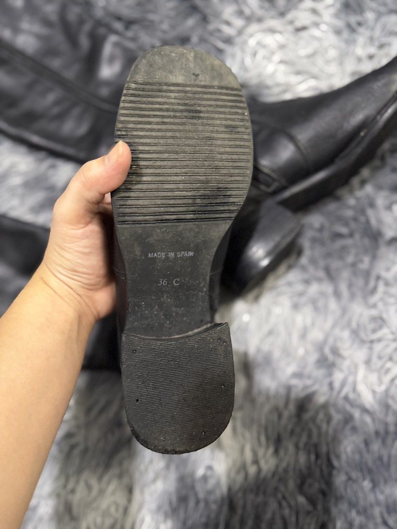 Black Leather Knee-High Boots - Made in Spain (Category: Boots) located in Trece Martires City. Submitted by raresen26 (Listing ID 1461847995, Image 2). Description: - Black leather knee-high boots - Size 36 - Side zipper closure - Block heel - Made in Spain - Shows creasing and wear on soles, good for everyday use.