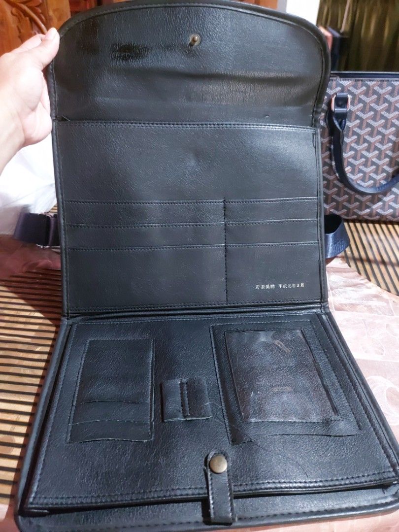 Black Leather Portfolio with Embossed Logo (Category: Briefcases) located in Manila. Submitted by veelafiera (Listing ID 1461860510, Image 2). Description: - Classic black leather portfolio - Secure flap closure with embossed logo - Minor scuffs and marks from normal use - Ideal for carrying documents or a tablet - Timeless design -Perfect for documents -Dimensions approx 11.5"x8.5".