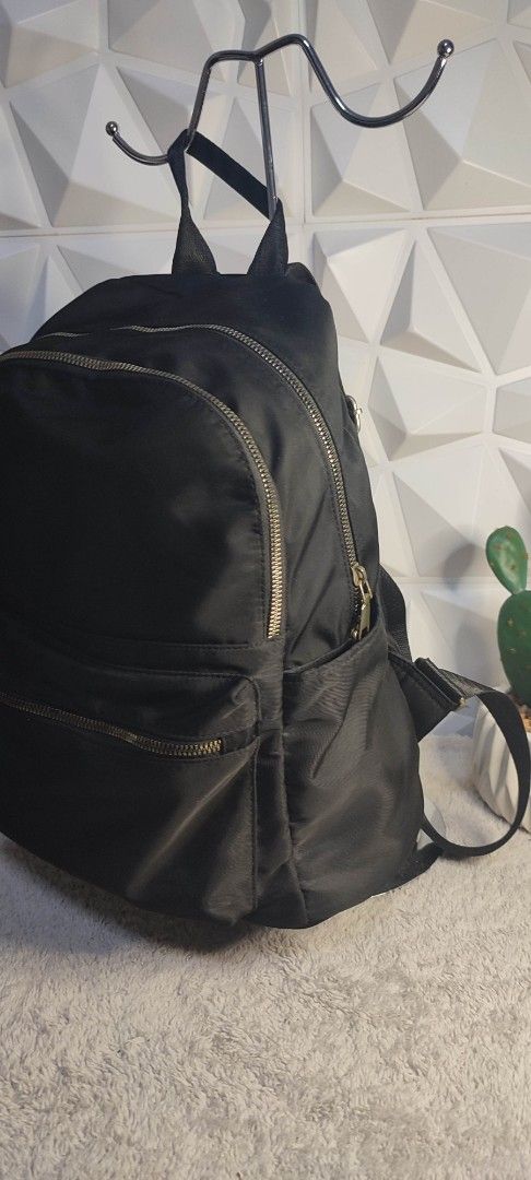 Black Nylon Backpack with Gold Zippers (Category: Backpacks) located in Pasig City. Submitted by xcess_baggage (Listing ID 1461889611, Image 3). Description: - Classic black backpack - Durable nylon material - Multiple zippered compartments for organization - Stylish gold-tone zippers - Adjustable shoulder straps for comfort - Ideal for daily use or travel.