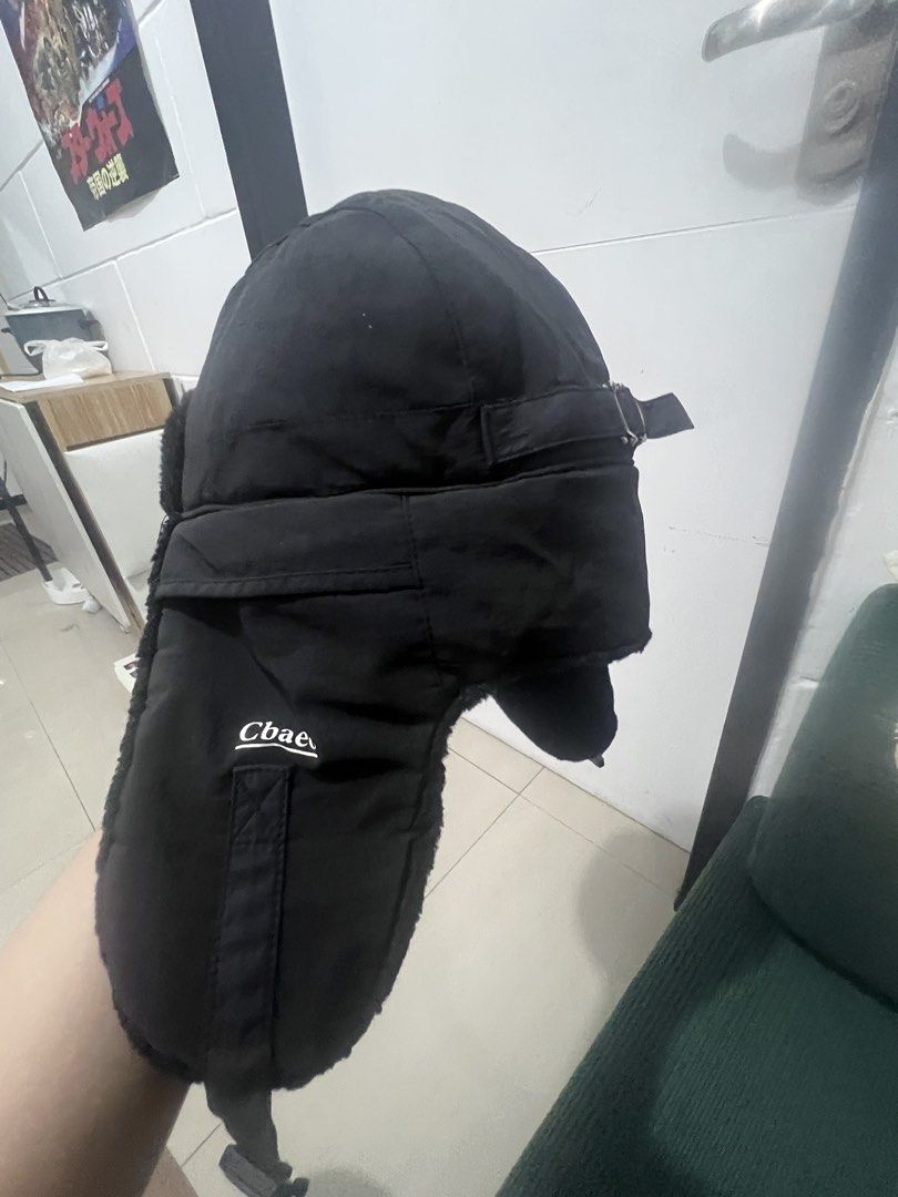 Black Trapper Hat Ushanka with Faux Fur Lining (Category: Caps & Hats) located in Caloocan City. Submitted by guaconerva97479 (Listing ID 1461963827, Image 3). Description: - Warm black trapper hat - Features ear flaps with buckle closure - Soft faux fur lining inside for extra warmth - Perfect for cold weather - One size fits most.