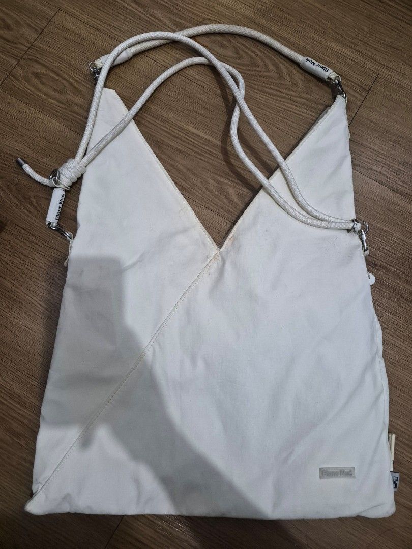 Blanc Nude Canvas Tote Bag (Category: Tote Bags) located in Quezon City. Submitted by paulaalarcon_ (Listing ID 1461918184, Image 1). Description: - Unique triangular white canvas tote bag by Blanc Nude. - Features stylish rope handles with metal hardware. - Ideal for everyday errands or as a chic beach bag..