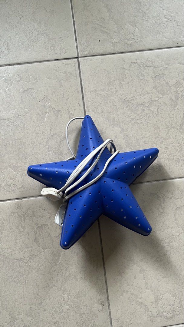 Blue Star Lamp with Plug (Category: Lighting) located in Manila. Submitted by tineemall (Listing ID 1461848721, Image 1). Description: - Unique blue star-shaped lamp - Features small holes all over for a diffused glow - Comes with a white cord and plug - Ideal for decorative purposes or as a soothing night light - Fully functional and works well ⚠️light not included ⚠️no light 📍Sta Mesa Manila ⚠️Buyer will shoulder the sfee .