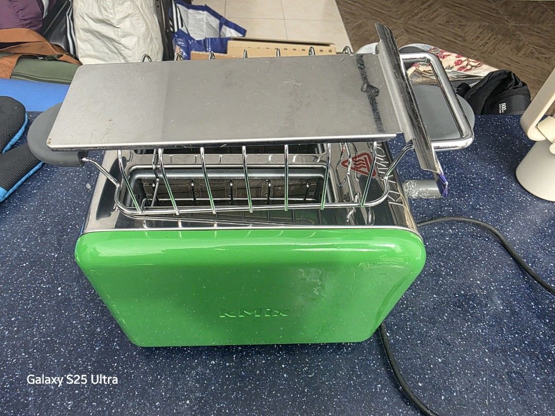 BREAD TOASTER (Category: Ovens & Toasters) located in Kuala Lumpur. Submitted by kben1981 (Listing ID 1461919819, Image 2). Description: FOR SALE: Kenwood kMix 2-Slice Toaster – Bright Green Classic Kenwood kMix toaster in that fun, vibrant green finish! Works perfectly — toasts evenly and heats up fast. ✅ Fully functional ✅ Stylish retro design ✅ 2 extra-wide slots ⚠️ Note: The control knob has some wear/defects as shown — still turns and works,