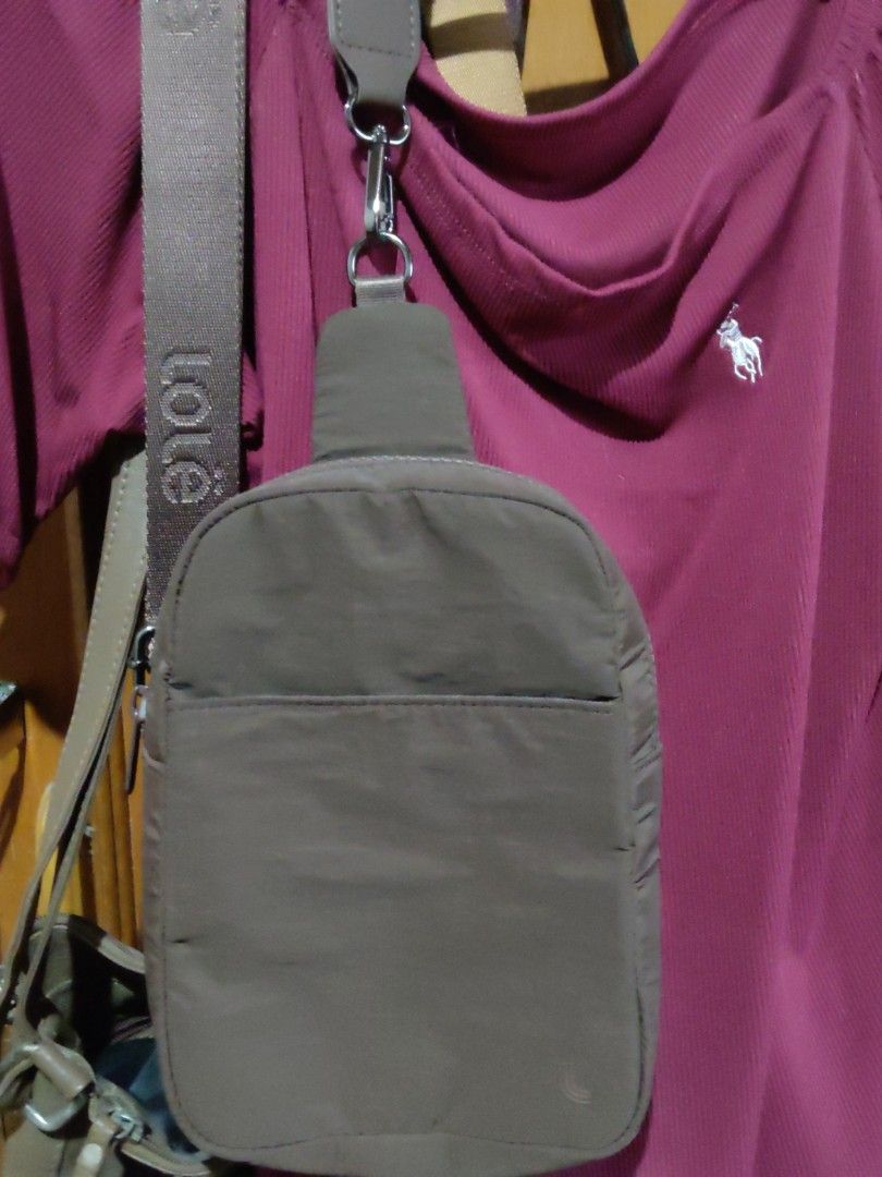 Brown Nylon Sling Bag with 'Lole' Strap (Category: Cross-body Bags) located in Pila. Submitted by heyz27 (Listing ID 1461863492, Image 1). Description: - Stylish brown nylon sling bag - Convenient front pocket for essentials - Durable strap with 'Lole' branding - Secure metal clasp closure - Ideal for everyday wear and tear.