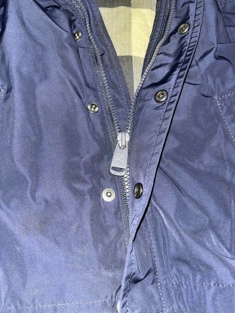 Burberry Children's Navy Blue Hooded Jacket (Category: Babies & Kids Fashion) located in Tabuk. Submitted by collectors_thrift_shop (Listing ID 1461955813, Image 2). Description: - Burberry Children's Jacket - Color: Navy Blue - Size: 24 Months - Iconic Burberry Check Lining - Hooded Design - Zip and Button Closure - Perfect for keeping your child warm and stylish.