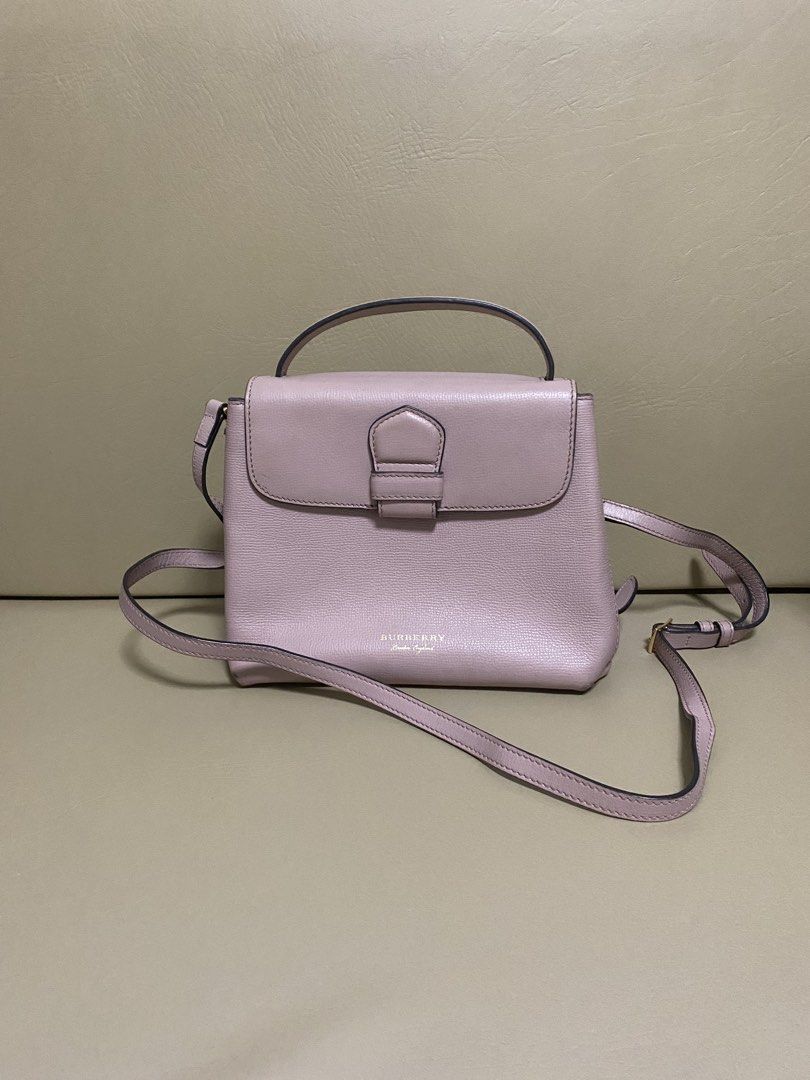 Burberry Leather Handbag with Shoulder Strap (Category: Luxury Bags & Wallets) located in Manila. Submitted by aikara683 (Listing ID 1461976798, Image 1). Description: - Light pink Burberry handbag - Textured leather material - Top handle and detachable shoulder strap - Gold buckle closure on front flap - Classic Burberry check lining - Versatile for everyday or special occasions - Authentic - hardware discoloration needs bag spa.