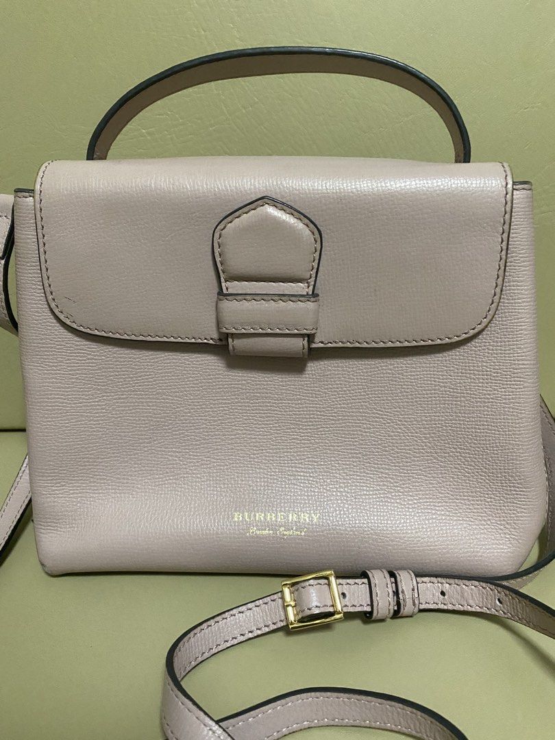 Burberry Leather Handbag with Shoulder Strap (Category: Luxury Bags & Wallets) located in Manila. Submitted by aikara683 (Listing ID 1461976798, Image 2). Description: - Light pink Burberry handbag - Textured leather material - Top handle and detachable shoulder strap - Gold buckle closure on front flap - Classic Burberry check lining - Versatile for everyday or special occasions - Authentic - hardware discoloration needs bag spa.