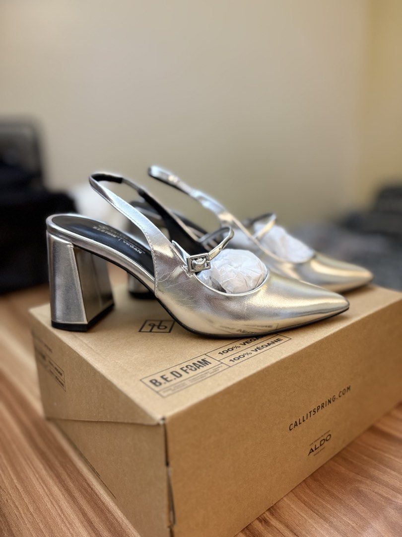 Call It Spring Silver Slingback Block Heels (Category: Heels) located in Manila. Submitted by amityclutter (Listing ID 1461939276, Image 1). Description: - Brand: Call It Spring - Style: Silver Slingback Heels - Size: 35 - Features: Pointed toe, buckle strap, chunky block heel - Material: 100% Vegan - Condition: Comes with original box - Versatility: Perfect for dressing up or down.