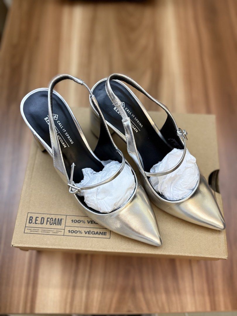 Call It Spring Silver Slingback Block Heels (Category: Heels) located in Manila. Submitted by amityclutter (Listing ID 1461939276, Image 2). Description: - Brand: Call It Spring - Style: Silver Slingback Heels - Size: 35 - Features: Pointed toe, buckle strap, chunky block heel - Material: 100% Vegan - Condition: Comes with original box - Versatility: Perfect for dressing up or down.
