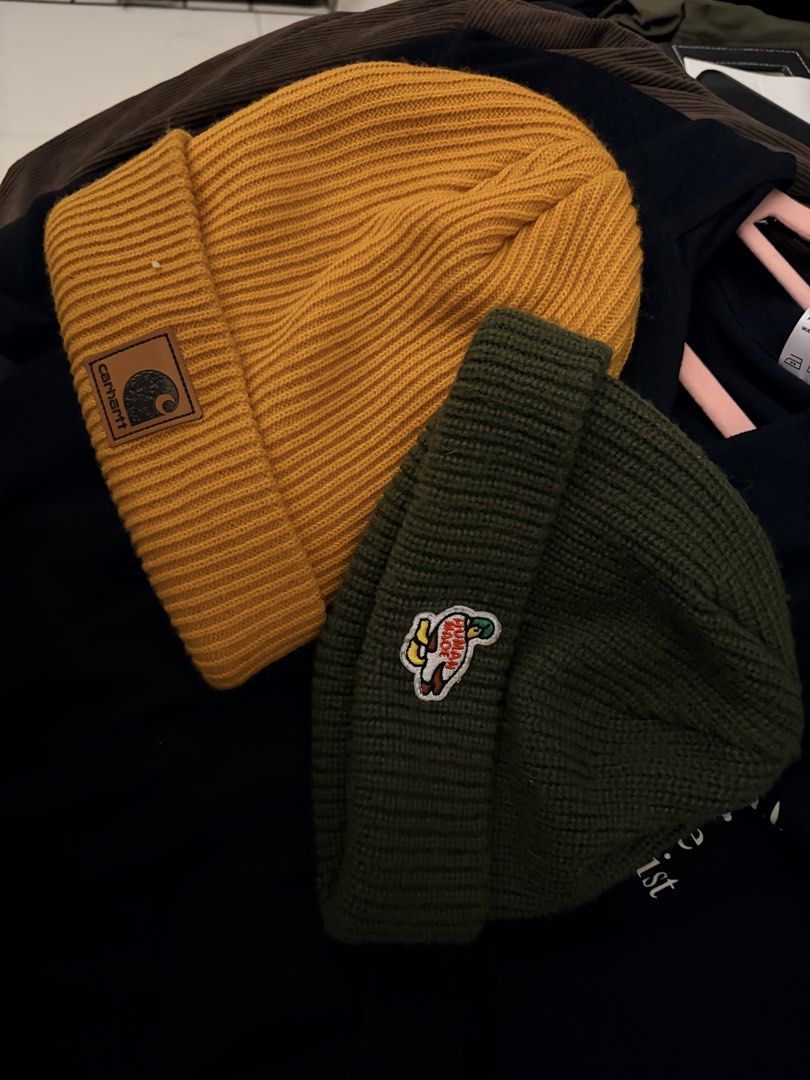 Carhartt & Human Made Beanies Bundle (Category: Hats & Beanies) located in Manila. Submitted by finderskeepersmnl_092026 (Listing ID 1461959348, Image 2). Description: - Bundle includes two ribbed knit beanies. - Carhartt beanie: Mustard yellow with classic logo patch. - Human Made beanie: Dark green with a cute duck patch. - Both are great for keeping warm..