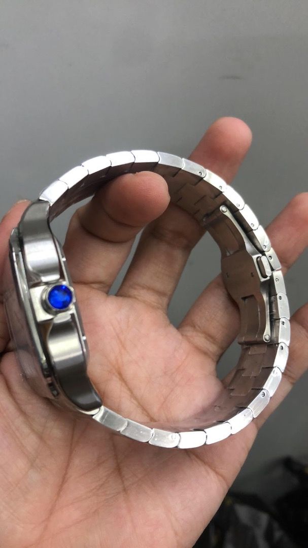 Cartier Santos Automatic Stainless Steel (Category: Luxury Watches) located in Caloocan City. Submitted by mrbigdreams (Listing ID 1461907117, Image 2). Description: - Authentic Cartier Santos watch - Automatic movement - Stainless steel bracelet - White dial with Roman numerals - Date window at 6 o'clock - Signature blue cabochon crown - Classic square case design - Versatile for daily wear or special events.