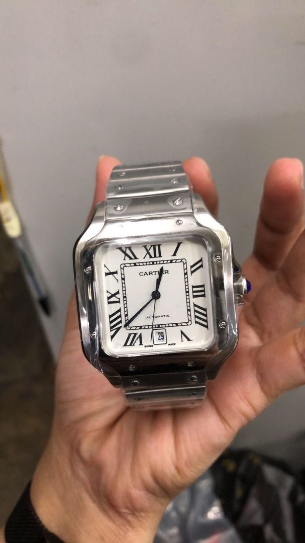 Cartier Santos Automatic Stainless Steel (Category: Luxury Watches) located in Caloocan City. Submitted by mrbigdreams (Listing ID 1461907117, Image 1). Description: - Authentic Cartier Santos watch - Automatic movement - Stainless steel bracelet - White dial with Roman numerals - Date window at 6 o'clock - Signature blue cabochon crown - Classic square case design - Versatile for daily wear or special events.