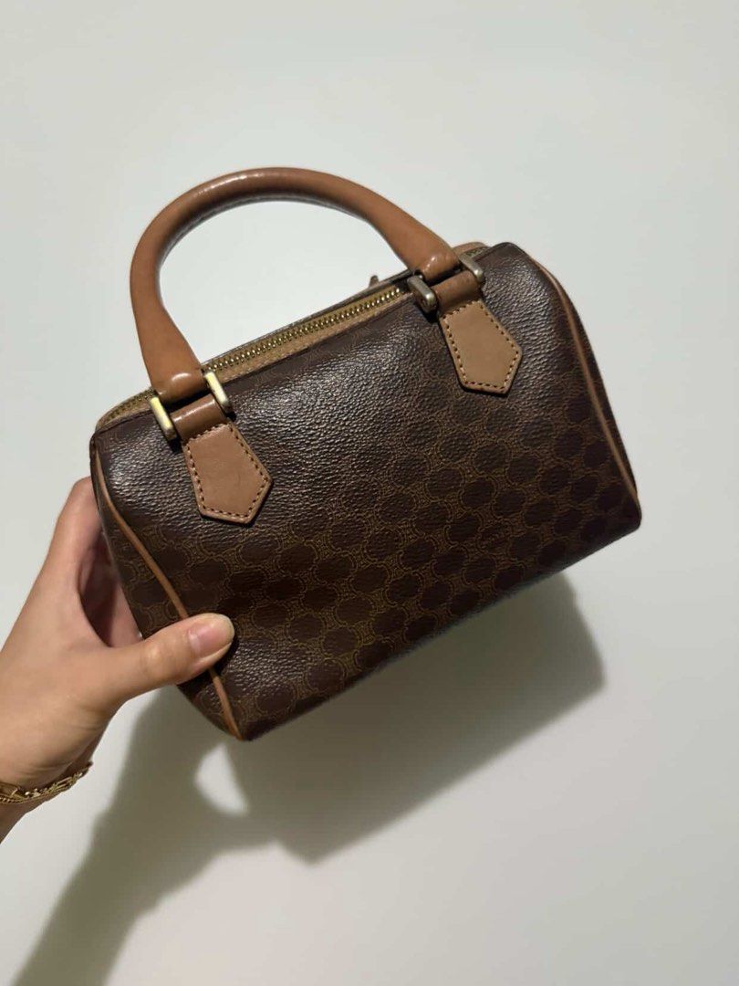 Celine Mini Boston Bag Monogram Brown (Category: Luxury Bags & Wallets) located in Manila. Submitted by hanagblibr77608 (Listing ID 1461875691, Image 2). Description: - Classic Celine mini Boston bag - Iconic monogram print - Color: Brown with tan leather accents - Closure: Zipper - Handles: Top handles for carrying - Size: Small and compact - Perfect for: Everyday use or a night out.