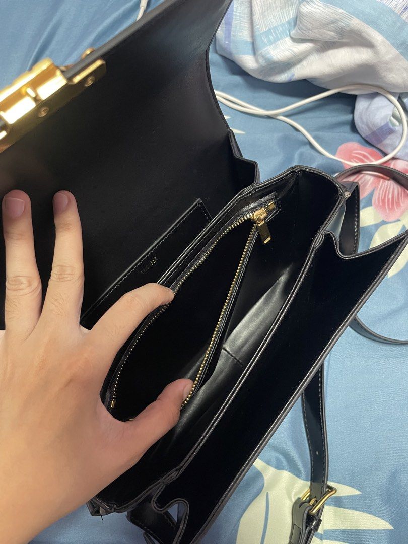 Celine Triomphe Bag Black Leather Gold Hardware (Category: Luxury Bags & Wallets) located in Jaen. Submitted by rocel_abergas (Listing ID 1461875081, Image 3). Description: - Classic black Celine bag - Iconic gold Triomphe clasp - Smooth and shiny leather - Interior zip pocket and main compartment - Adjustable strap for crossbody or shoulder wear - Gold hardware details - Versatile for day or night use.