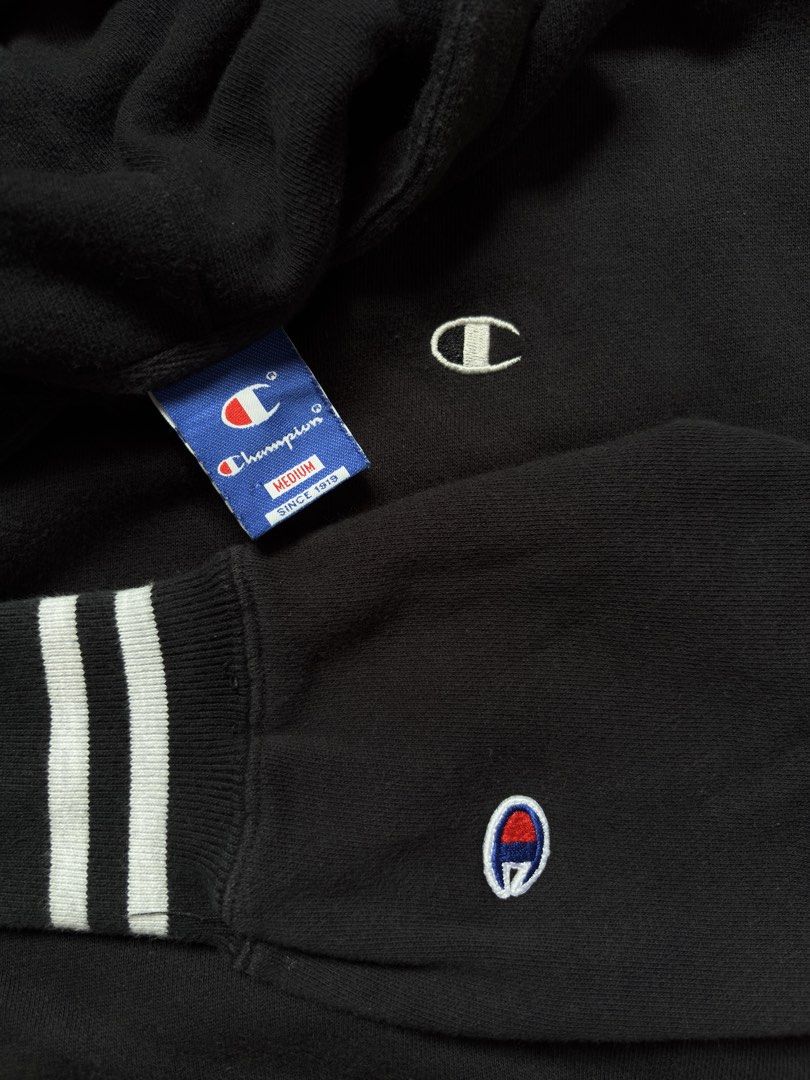 Champion Black Hoodie Medium Striped Cuffs (Category: Coats, Jackets and Outerwear) located in Manila. Submitted by pusherneeds (Listing ID 1461909258, Image 2). Description: - Classic black Champion hoodie - Iconic C logo on chest and sleeve - Ribbed cuffs with white stripes - Drawstring hood - Comfortable and casual - Great for everyday wear.