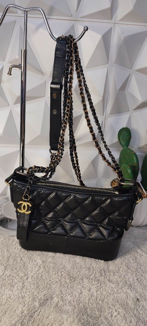 Chanel Black Quilted Leather Chain Shoulder Bag (Category: Luxury Bags & Wallets) located in Pasig City. Submitted by xcess_baggage (Listing ID 1461823425, Image 3). Description: - Black quilted leather - Gold chain straps - Zipper closure - Red interior lining - Made in Italy - Classic, versatile design for day or night.
