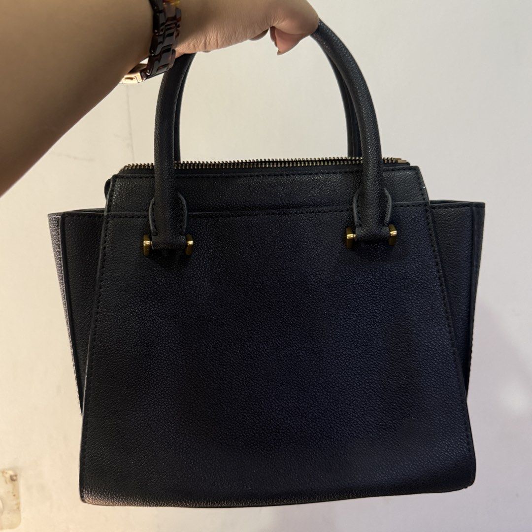 Charles & Keith Black Trapeze Tote Bag (Category: Luxury Bags & Wallets) located in Pateros City. Submitted by sachiereyes (Listing ID 1462005085, Image 2). Description: - Classic black top handle bag by Charles & Keith - Structured design with elegant gold hardware - Secure zip closure - Spacious interior compartment - Includes a detachable shoulder strap for versatile wear - Ideal for both daily use and dressing up outfits.