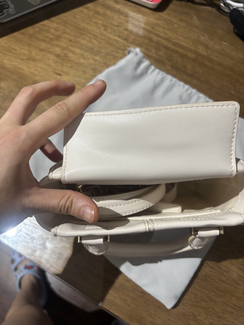 Charles & Keith White Top Handle Bag (Category: Luxury Bags & Wallets) located in Paranaque City. Submitted by corinne_see (Listing ID 1461921716, Image 3). Description: - Brand: Charles & Keith - Color: White - Style: Top handle bag - Design: Structured with stitched panel details - Straps: Top handle and detachable shoulder strap - Hardware: Gold accents - Includes: Original dust bag - Versatile: Suitable for daily use or special occasions.