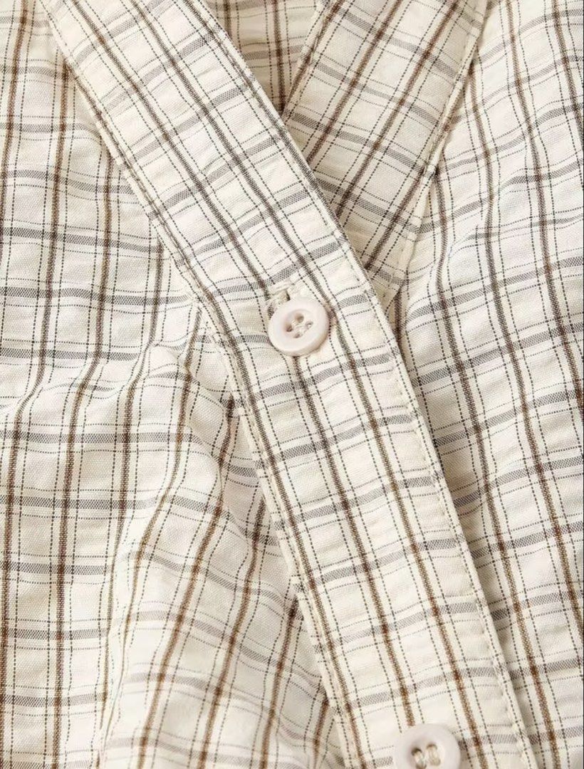 Checkered Wrap Long Sleeve Blouse (Category: Blouses) located in Villasis. Submitted by juliaxgamboa (Listing ID 1461881972, Image 3). Description: - Cream and brown checkered wrap blouse - Long sleeves - Button closure at the front - Cinched waist detail at the back - Versatile for smart casual looks with skirts or trousers.