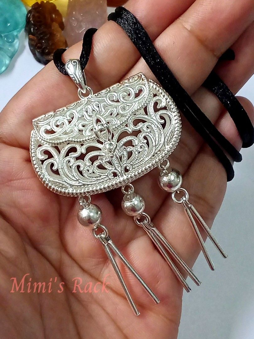 Chinese-Style Treasure Pouch Rope Necklace (Category: Necklaces) located in Taguig. Submitted by mimisrack (Listing ID 1461869949, Image 1). Description: 🩶Elegant and highly detailed Chinese-inspired silver-tone pendant necklace featuring a beautiful ornate treasure pouch / coin purse design. -The pendant has intricate openwork scroll and floral-style detailing, a decorative central motif, and three long dangling tassels for an eye-catching trad