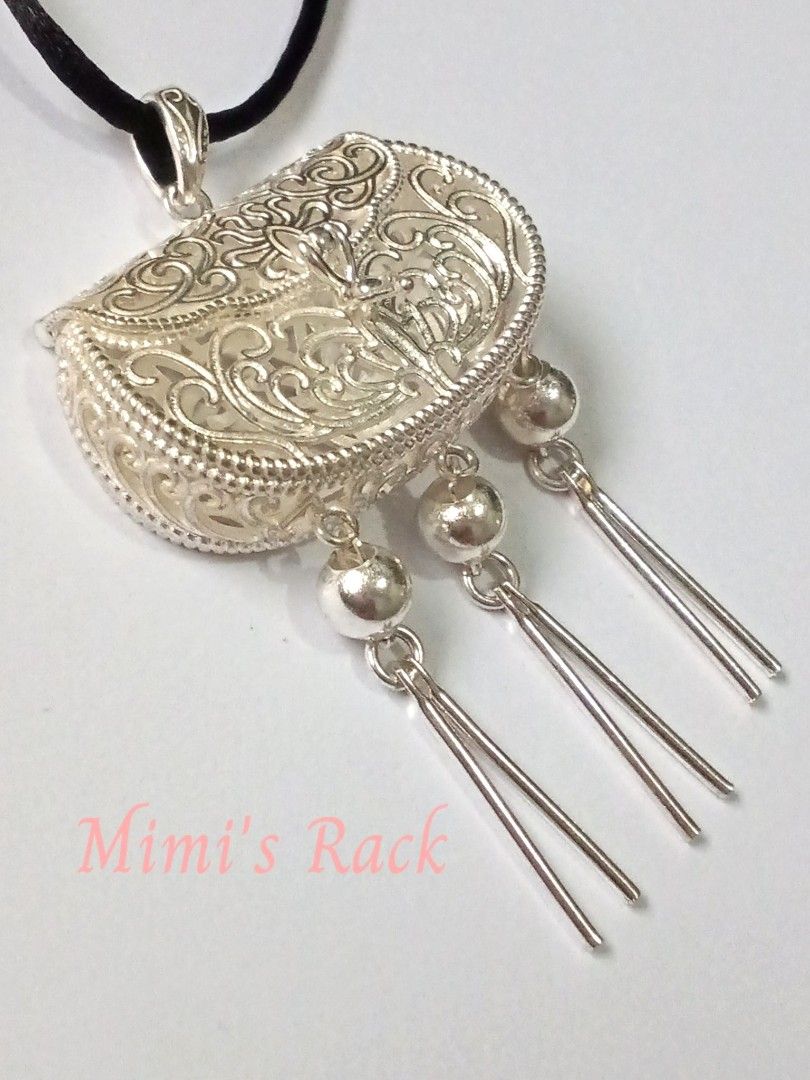 Chinese-Style Treasure Pouch Rope Necklace (Category: Necklaces) located in Taguig. Submitted by mimisrack (Listing ID 1461869949, Image 3). Description: 🩶Elegant and highly detailed Chinese-inspired silver-tone pendant necklace featuring a beautiful ornate treasure pouch / coin purse design. -The pendant has intricate openwork scroll and floral-style detailing, a decorative central motif, and three long dangling tassels for an eye-catching trad