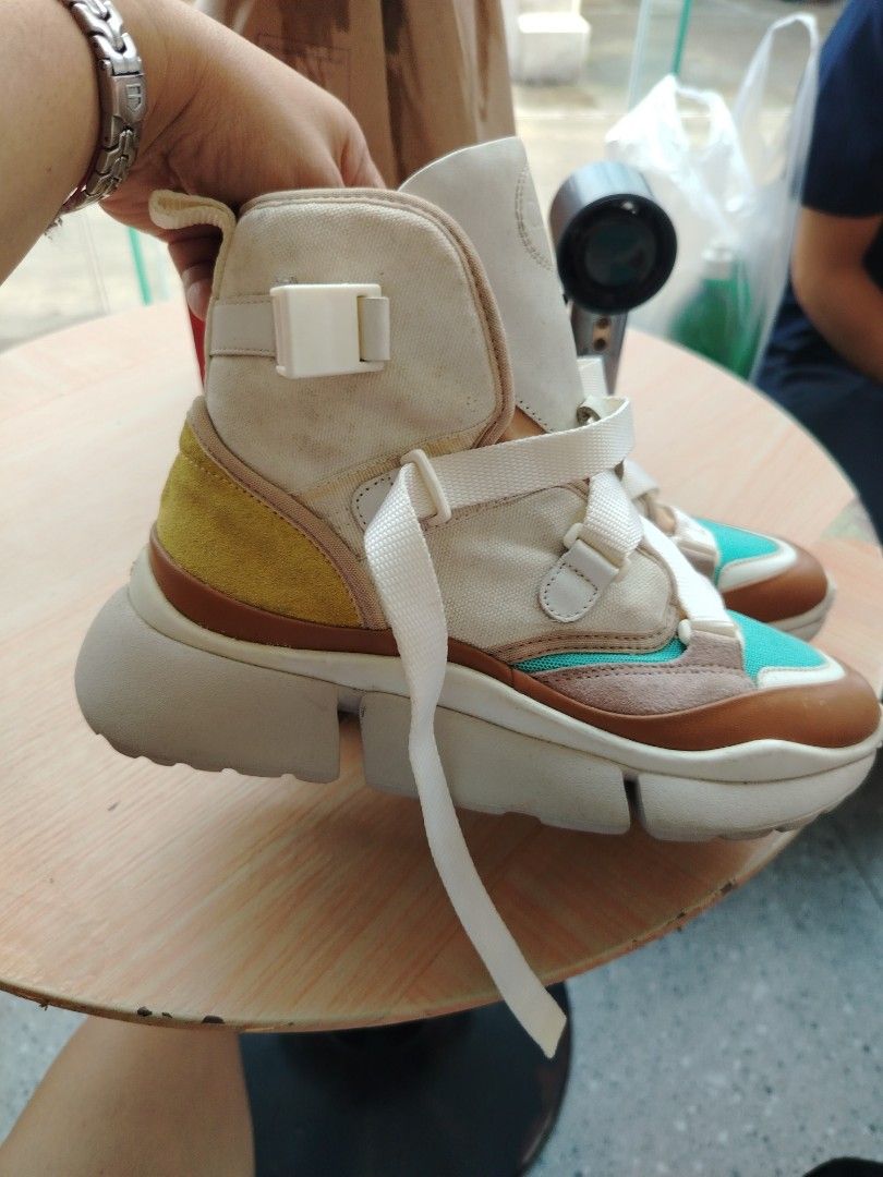 Chloe Sonnie High Top Sneakers, size 7 (Category: Sneakers) located in Manila. Submitted by purediamond888 (Listing ID 1462000993, Image 3). Description: - Chloe Sonnie high top sneakers - Unique color block design: beige, tan, pink, and turquoise panels - Chunky sole for comfort and style - Lace-up closure with adjustable straps - Perfect for adding a pop of color - A true statement piece.