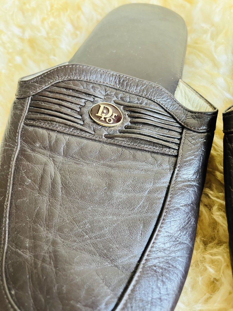 Christian Dior Leather Slippers (Category: Slippers and slides) located in Davao. Submitted by goodthingsph_ (Listing ID 1462033571, Image 2). Description: Size8 26cm - Color: Dark brown - Style: Classic slip-on - Features: Iconic Dior logo on the front - Condition: Soles show some wear, small scuff mark on the toe of one slipper - Ideal for: Lounging at home.