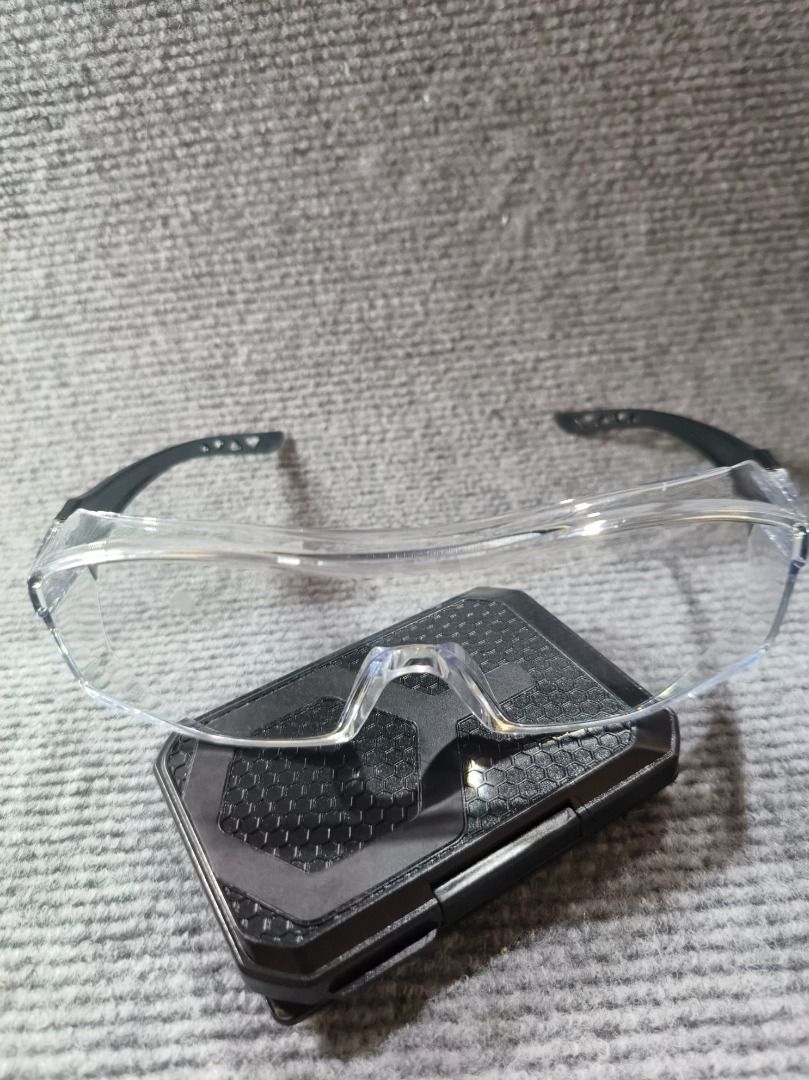 Clear Safety Glasses with Black Arms (Category: Sunglasses & Eyewear) located in San Leonardo. Submitted by burgossanleonardo.12345 (Listing ID 1461829809, Image 1). Description: - Clear safety glasses with black arms - Wrap-around design for excellent coverage - Lenses marked to meet safety standards - Protects eyes during various tasks - Lightweight and comfortable for extended wear.