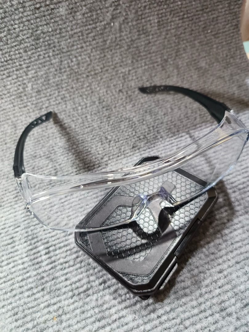 Clear Safety Glasses with Black Arms (Category: Sunglasses & Eyewear) located in San Leonardo. Submitted by burgossanleonardo.12345 (Listing ID 1461829809, Image 2). Description: - Clear safety glasses with black arms - Wrap-around design for excellent coverage - Lenses marked to meet safety standards - Protects eyes during various tasks - Lightweight and comfortable for extended wear.