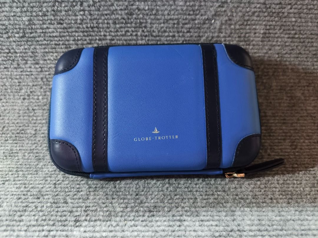 CLOTH & COIN Blue Leather Suitcase Style Pouch (Category: Purses & Pouches) located in San Leonardo. Submitted by burgossanleonardo.12345 (Listing ID 1461821148, Image 1). Description: - Adorable blue pouch shaped like a mini suitcase. - Features a stylish geometric pattern on the inside. - Secure zipper closure with a convenient wrist strap. - Ideal for organizing cards, coins, makeup, and other small essentials. - Compact size: approximately 6 