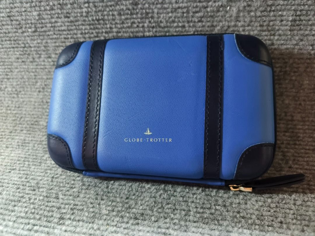 CLOTH & COIN Blue Leather Suitcase Style Pouch (Category: Purses & Pouches) located in San Leonardo. Submitted by burgossanleonardo.12345 (Listing ID 1461821148, Image 2). Description: - Adorable blue pouch shaped like a mini suitcase. - Features a stylish geometric pattern on the inside. - Secure zipper closure with a convenient wrist strap. - Ideal for organizing cards, coins, makeup, and other small essentials. - Compact size: approximately 6 