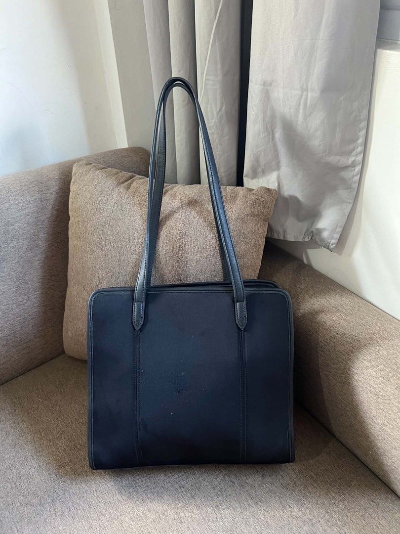 Coach Black Leather Tote Bag (Category: Tote Bags) located in Manila. Submitted by vferrer05190505 (Listing ID 1461806361, Image 3). Description: - Classic black Coach tote bag - Durable material with leather trim - Spacious interior for essentials - Interior zippered pocket - Includes Coach hang tag - Ideal for work or everyday use.