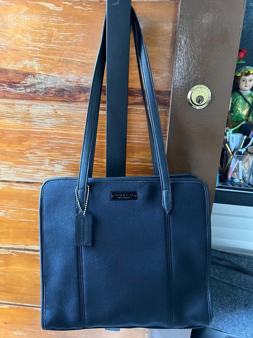 Coach Black Leather Tote Bag (Category: Tote Bags) located in Manila. Submitted by vferrer05190505 (Listing ID 1461806361, Image 1). Description: - Classic black Coach tote bag - Durable material with leather trim - Spacious interior for essentials - Interior zippered pocket - Includes Coach hang tag - Ideal for work or everyday use.