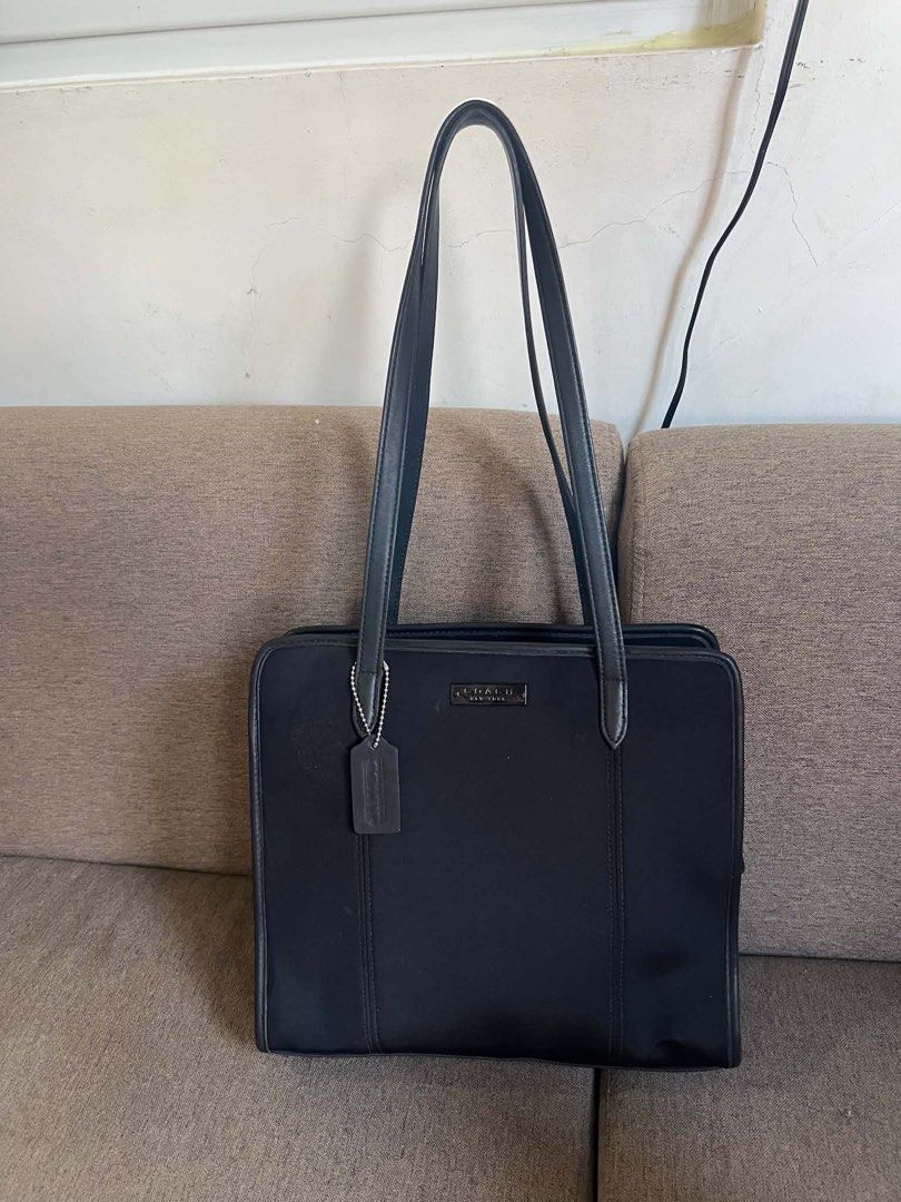 Coach Black Leather Tote Bag (Category: Tote Bags) located in Manila. Submitted by vferrer05190505 (Listing ID 1461806361, Image 2). Description: - Classic black Coach tote bag - Durable material with leather trim - Spacious interior for essentials - Interior zippered pocket - Includes Coach hang tag - Ideal for work or everyday use.