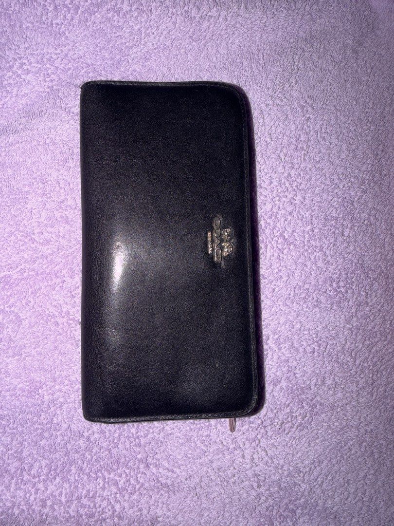 Coach Black Leather Wallet (Category: Wallets & Card holders) located in Manila. Submitted by floratheexplorer09 (Listing ID 1461822122, Image 1). Description: - Genuine black leather Coach wallet - Secure snap closure - Convenient zip-around compartment - Ample card slots for all your cards - Clear ID window for easy access - Perfect for keeping your essentials organized.