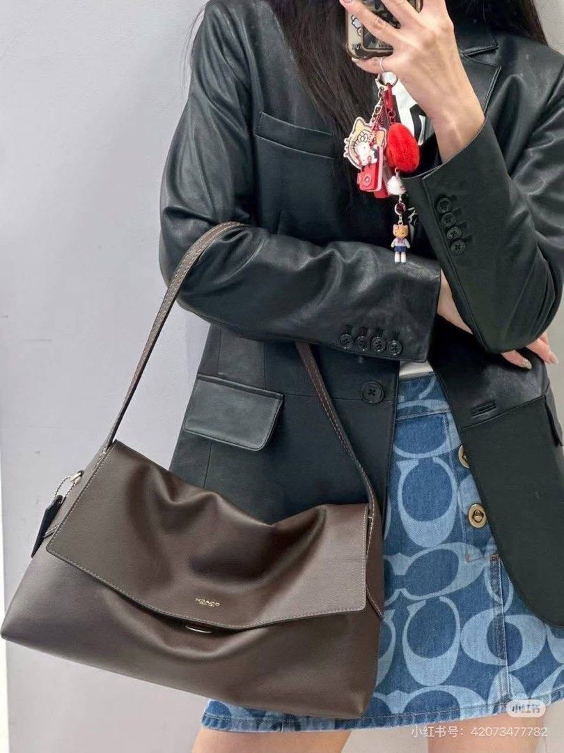 Coach Brown Leather Shoulder Bag with Charm (Category: Luxury Bags & Wallets) located in Quezon City. Submitted by _fculture (Listing ID 1461909267, Image 2). Description: - Coach brown leather shoulder bag - Soft and slouchy design - Comes with a cute pink elephant charm - Ideal for everyday use - Spacious interior - Smooth leather with a beautiful sheen Used twice. Size is 30cm. RFS: sponty buy & need funds Bought it for 2,400.