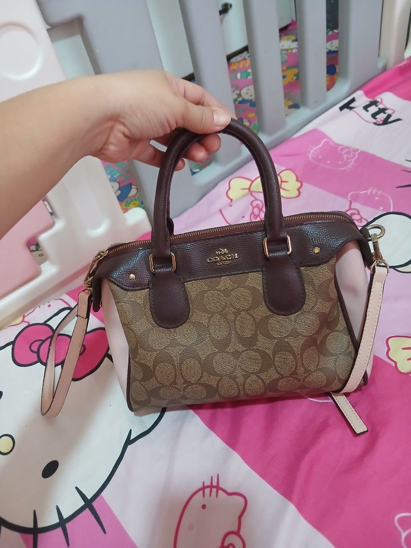Coach Monogram Canvas Leather Trim Satchel Bag (Category: Luxury Bags & Wallets) located in Manila. Submitted by pretty0099 (Listing ID 1461864288, Image 2). Description: - Coach monogram canvas satchel bag - Color: Brown and pink - Material: Leather trim and handles - Closure: Zipper - Strap: Detachable shoulder strap included - Hardware: Gold details - Interior: Zip pocket - Ideal for: Everyday use.