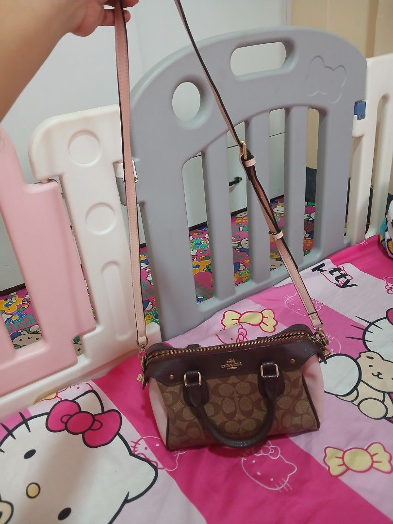Coach Monogram Canvas Leather Trim Satchel Bag (Category: Luxury Bags & Wallets) located in Manila. Submitted by pretty0099 (Listing ID 1461864288, Image 3). Description: - Coach monogram canvas satchel bag - Color: Brown and pink - Material: Leather trim and handles - Closure: Zipper - Strap: Detachable shoulder strap included - Hardware: Gold details - Interior: Zip pocket - Ideal for: Everyday use.