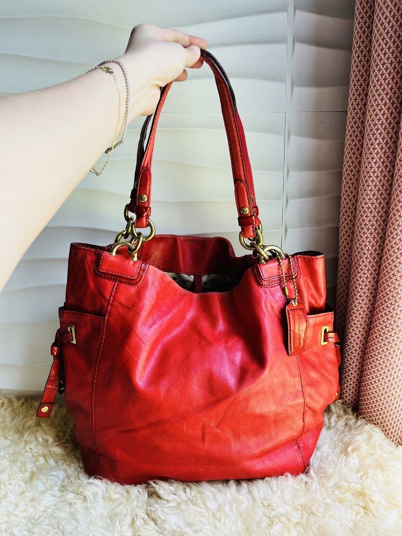 Coach Red Leather Shoulder Bag (Category: Luxury Bags & Wallets) located in Davao. Submitted by goodthingsph_ (Listing ID 1462034017, Image 1). Description: - Genuine red leather Coach shoulder bag - Elegant gold hardware - Playful polka dot interior lining - Spacious main compartment - Two convenient side pockets with drawstring details - Beautiful natural leather sheen - Authentic Coach hangtag included - Ideal for everyday wear.
