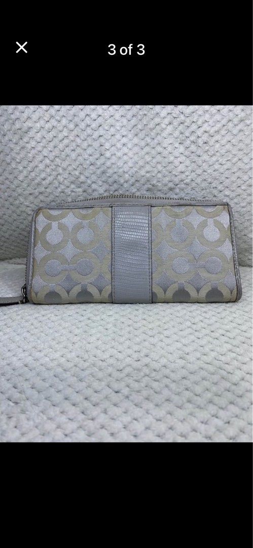 Coach Signature C Zip Around Wallet Silver (Category: Wallets & Card holders) located in Manila. Submitted by abigailpat47098 (Listing ID 1462024062, Image 3). Description: - Coach wallet in signature C pattern - Color: Silver and Light Grey - Closure: Zip around - Interior: Plenty of card slots and compartments for organization - Condition: Shows some signs of wear on the exterior and zipper pull.