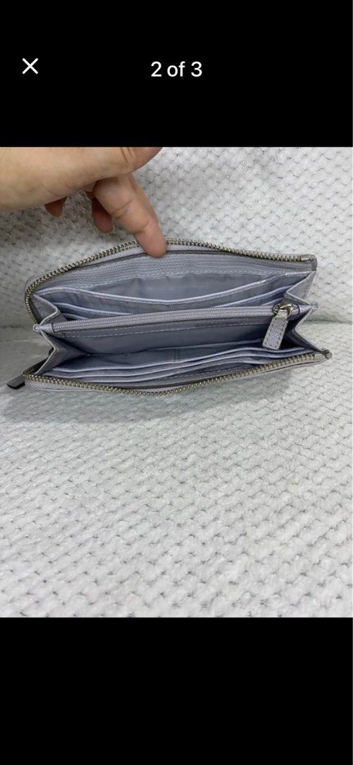 Coach Signature C Zip Around Wallet Silver (Category: Wallets & Card holders) located in Manila. Submitted by abigailpat47098 (Listing ID 1462024062, Image 2). Description: - Coach wallet in signature C pattern - Color: Silver and Light Grey - Closure: Zip around - Interior: Plenty of card slots and compartments for organization - Condition: Shows some signs of wear on the exterior and zipper pull.