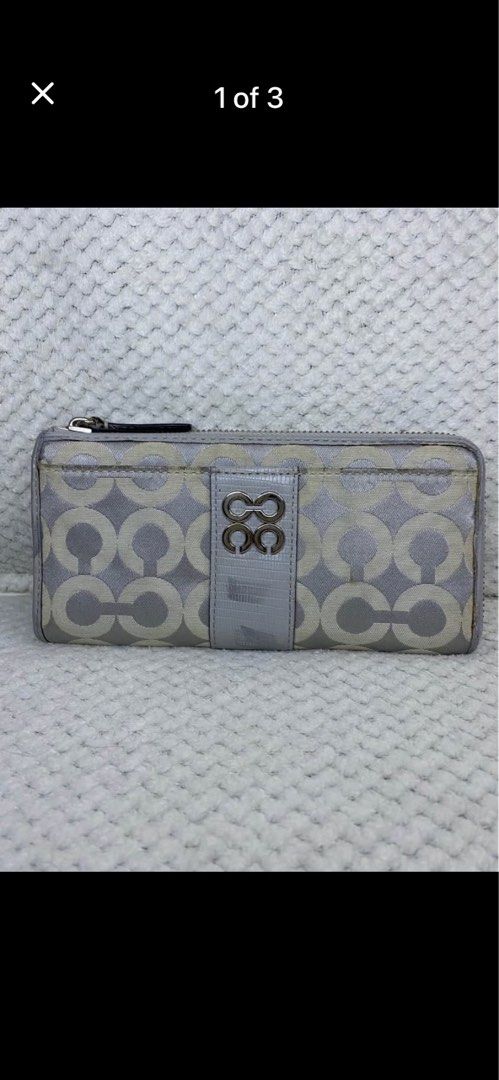 Coach Signature C Zip Around Wallet Silver (Category: Wallets & Card holders) located in Manila. Submitted by abigailpat47098 (Listing ID 1462024062, Image 1). Description: - Coach wallet in signature C pattern - Color: Silver and Light Grey - Closure: Zip around - Interior: Plenty of card slots and compartments for organization - Condition: Shows some signs of wear on the exterior and zipper pull.