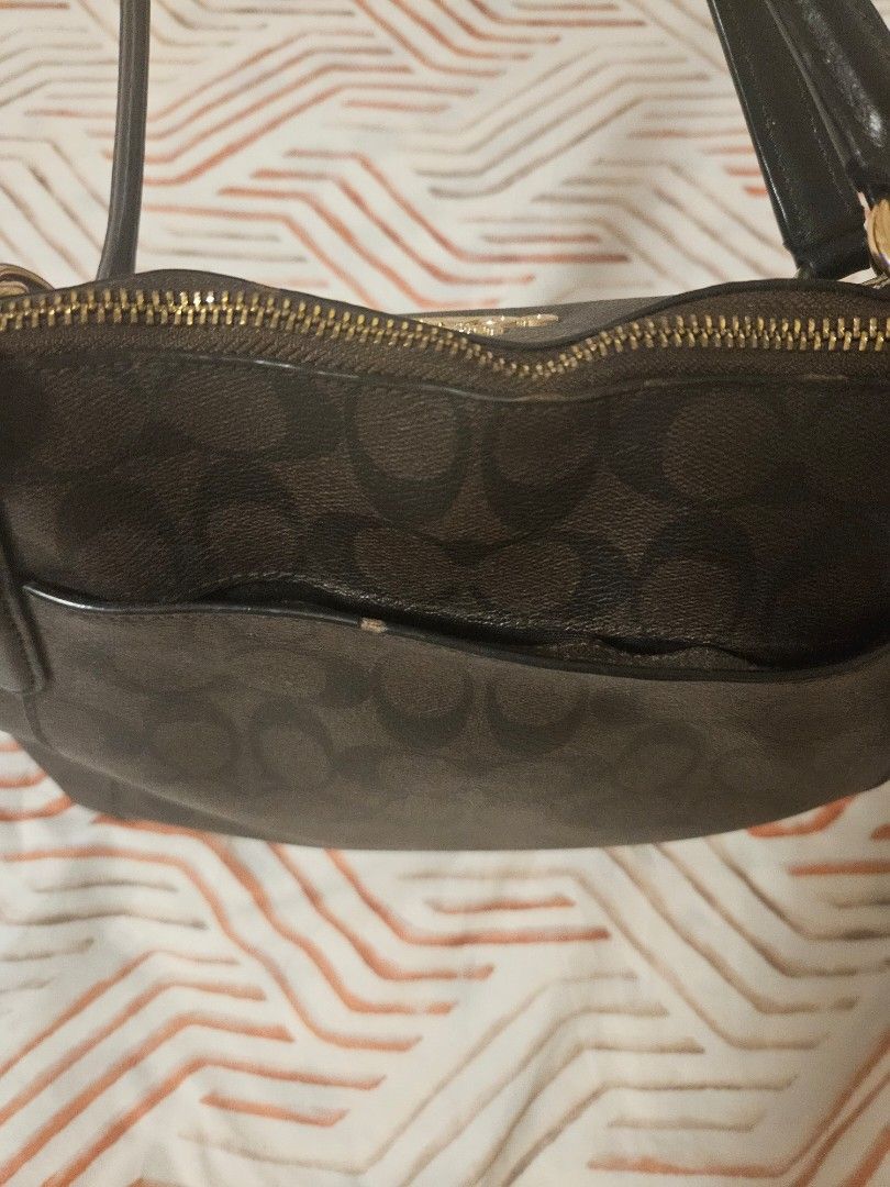 Coach Signature Monogram Tote Bag (Category: Luxury Bags & Wallets) located in Manila. Submitted by gcprime (Listing ID 1461834163, Image 3). Description: - Classic Coach tote bag - Color: Dark brown - Signature C monogram pattern - Gold hardware details - Zipper closure - Comfortable handle length - Spacious interior - Ideal for everyday use - with few chips that could be seen in the photos - Price listed is slightly negotiable.