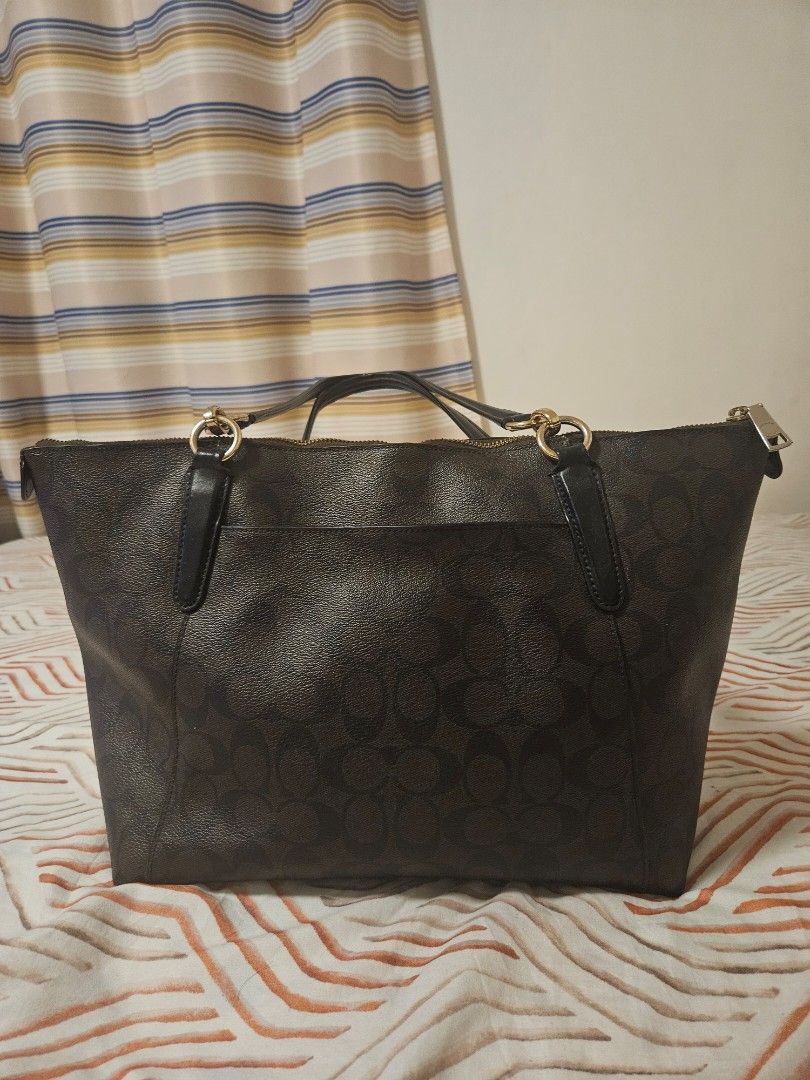 Coach Signature Monogram Tote Bag (Category: Luxury Bags & Wallets) located in Manila. Submitted by gcprime (Listing ID 1461834163, Image 2). Description: - Classic Coach tote bag - Color: Dark brown - Signature C monogram pattern - Gold hardware details - Zipper closure - Comfortable handle length - Spacious interior - Ideal for everyday use - with few chips that could be seen in the photos - Price listed is slightly negotiable.